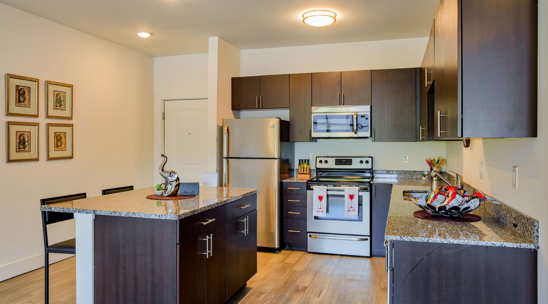 Apartment kitchen with island and brown cabinets