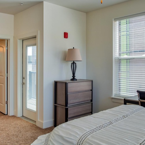 Unwind in your own bedroom, sans bunkbeds a bedroom with a bed and a lamp