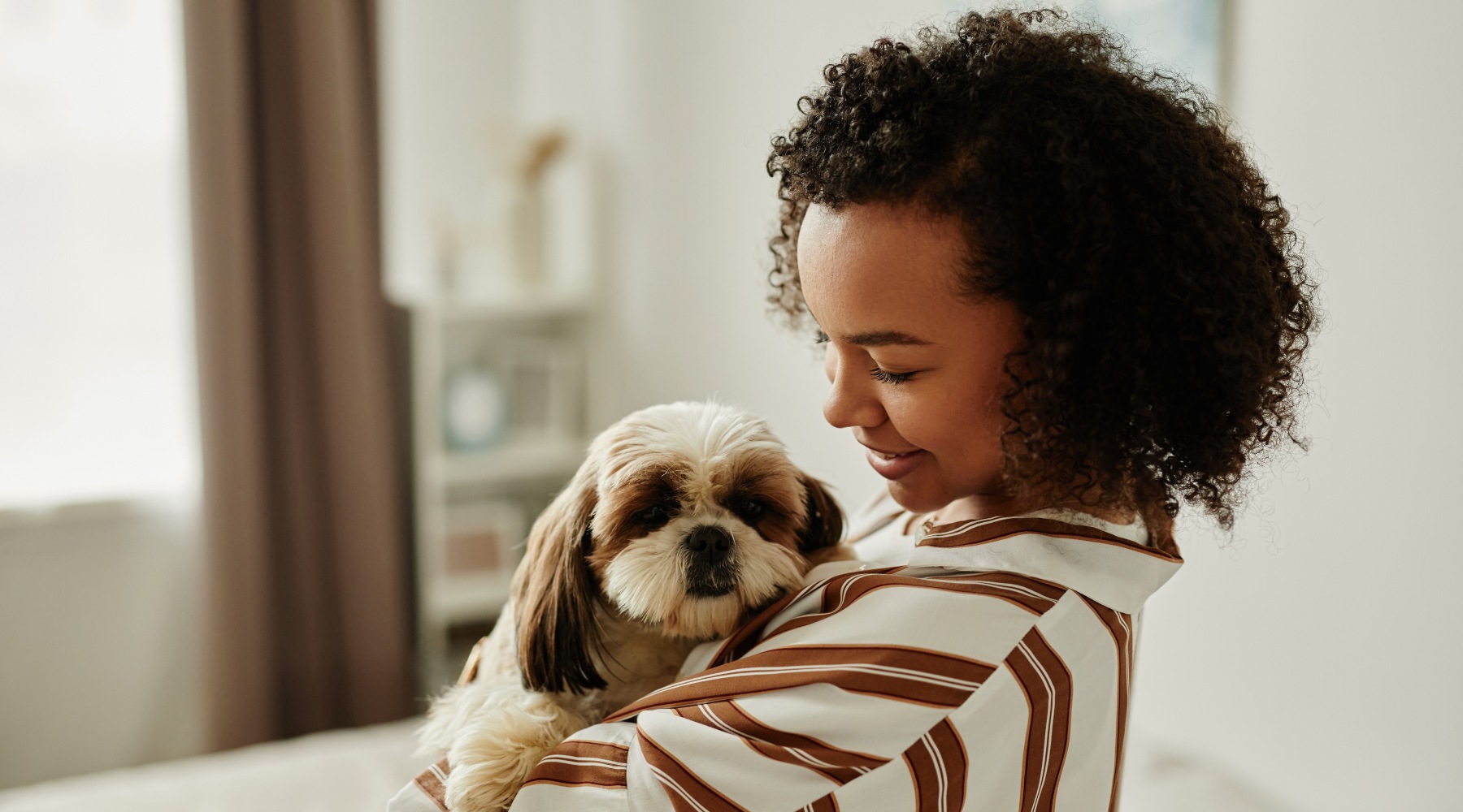 Pet-friendly IU Apartments Girl holding her dog